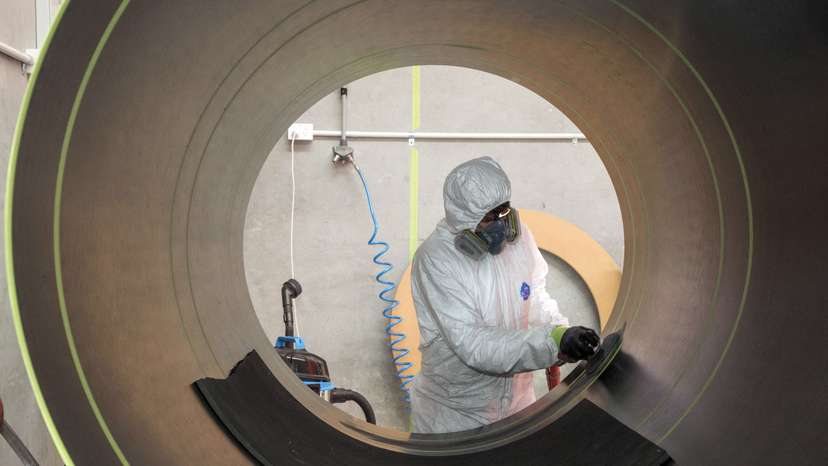 A Rocket Lab technician cleans a fuselage in Auckland, New Zealand