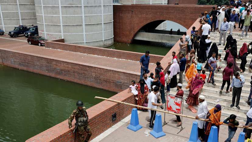 People gather at the entrance of the Parliament Building after Bangladeshi PM Hasina's resignation, in Dhaka