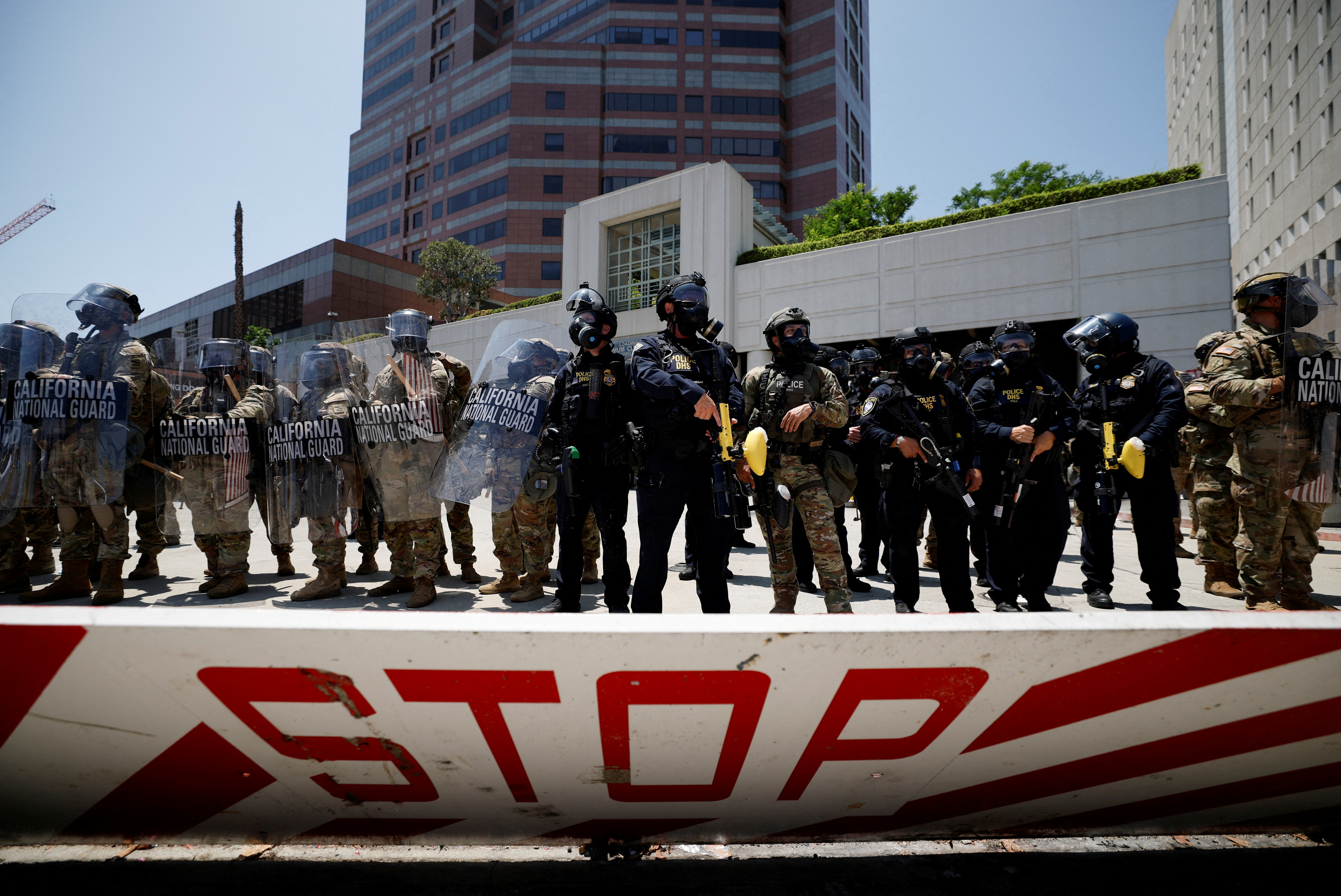 California National Guard troops stand outside the Edward R. Roybal federal building, in Los Angeles