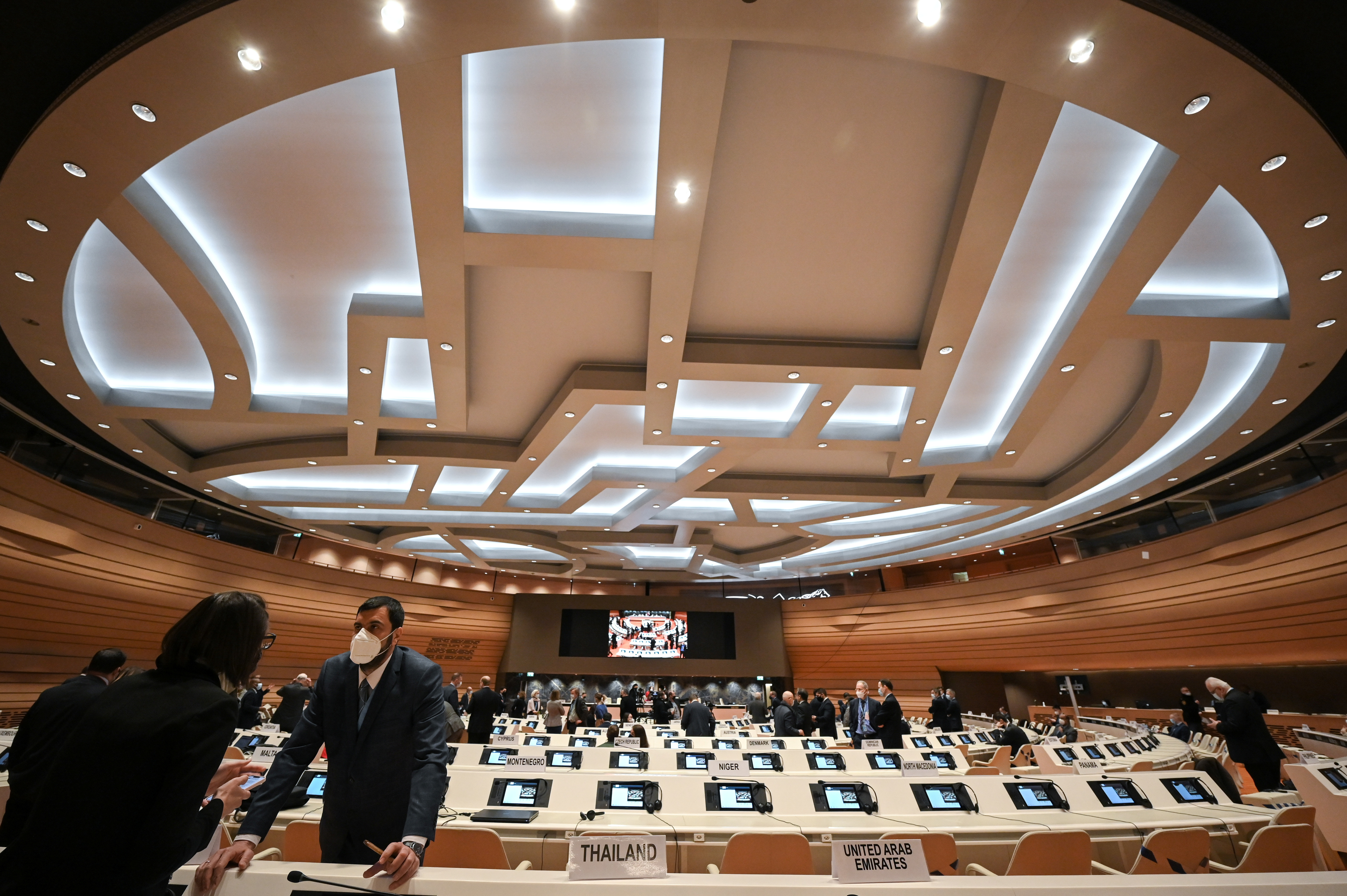 Delegates speak with each other prior to a session of the Conference on Disarmament, in Geneva