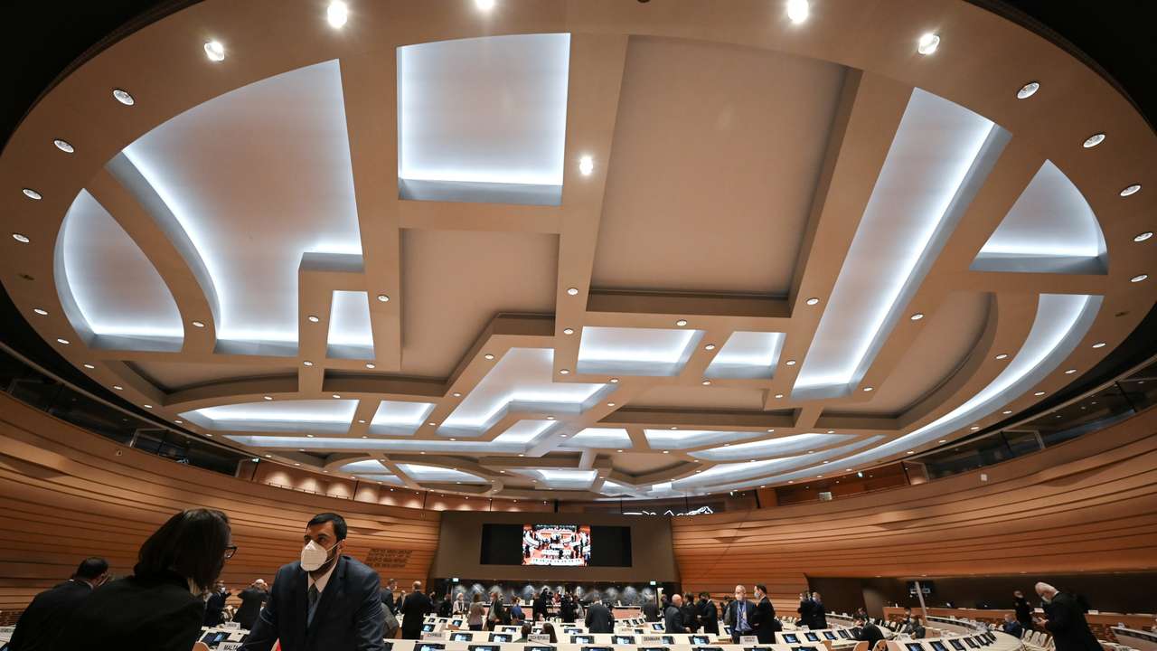 Delegates speak with each other prior to a session of the Conference on Disarmament, in Geneva
