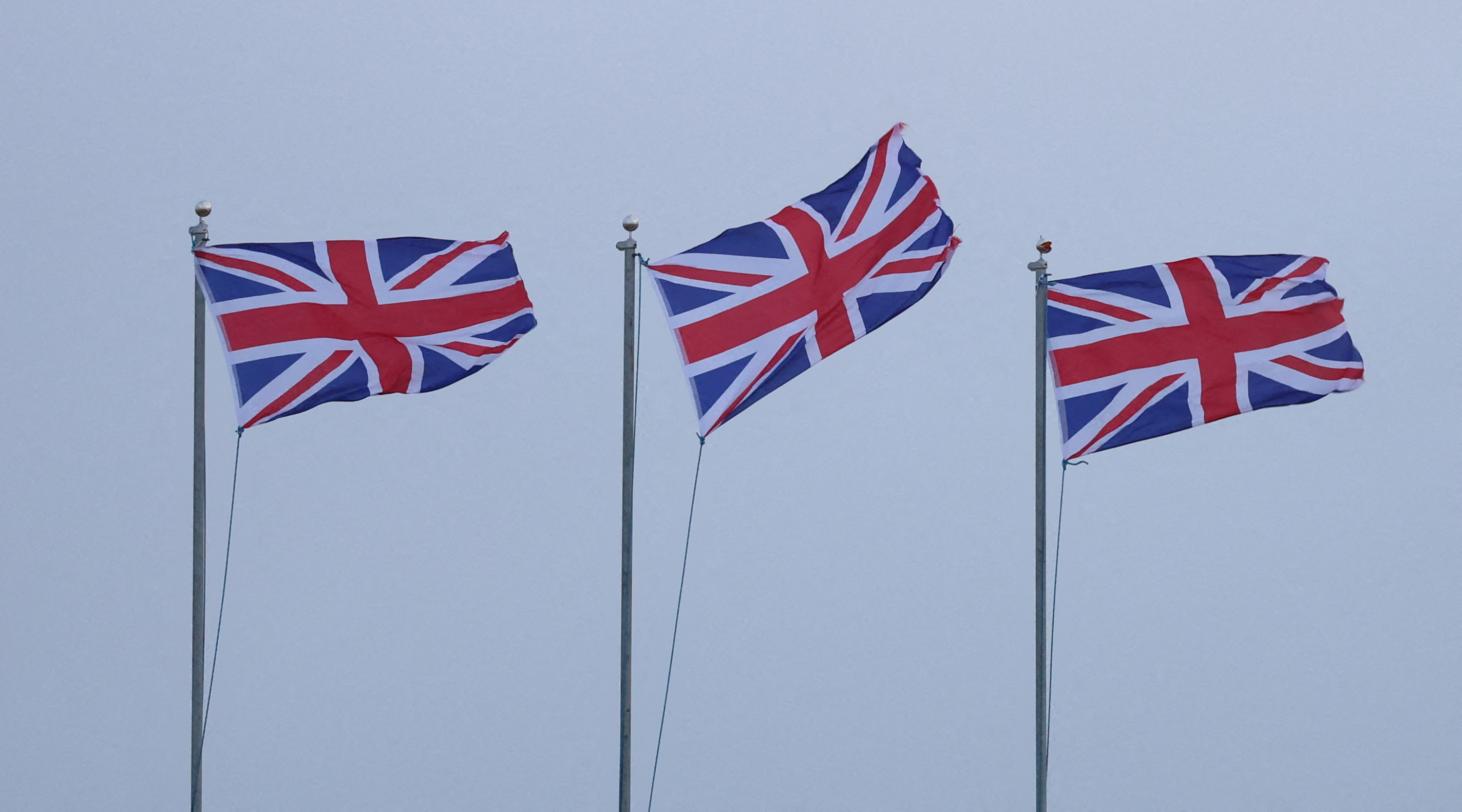 Union Jack flags blow in strong winds brought by Storm Lilian outside Fort Perch Rock in New Brighton, Britain