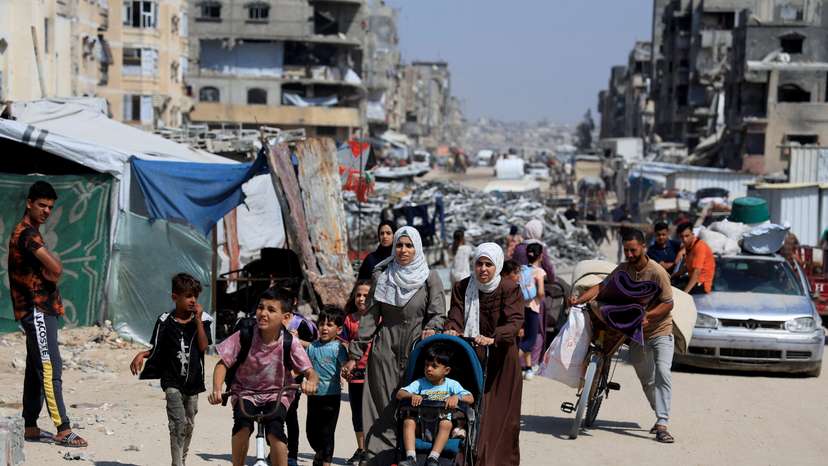Palestinians carry their belongings as they flee their homes after the Israeli army issued evacuation, in Khan Younis