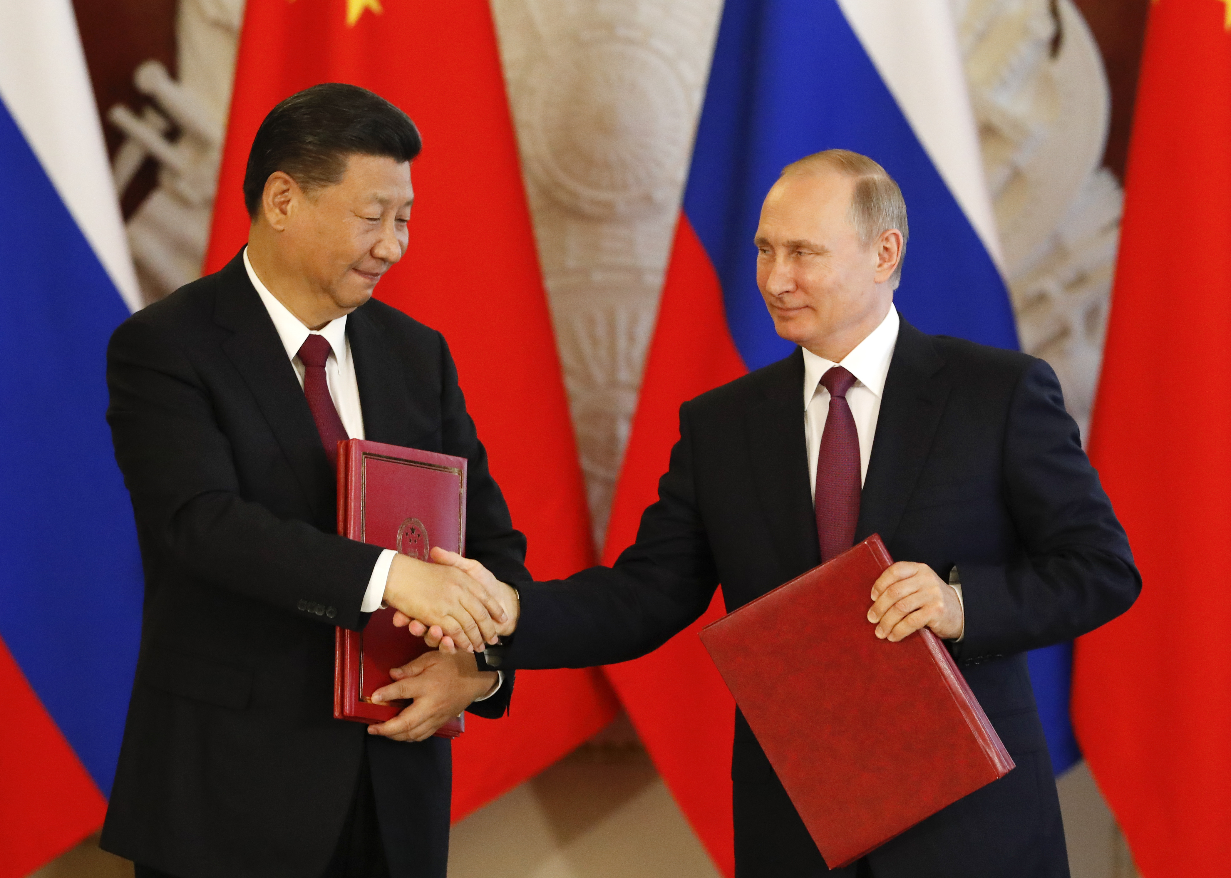 Russian President Vladimir Putin and his Chinese counterpart Xi Jinping attend a signing ceremony in Moscow