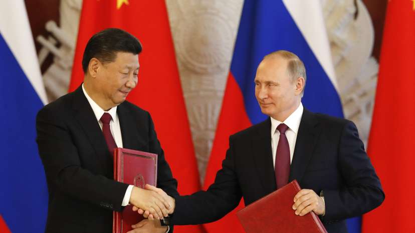 Russian President Vladimir Putin and his Chinese counterpart Xi Jinping attend a signing ceremony in Moscow