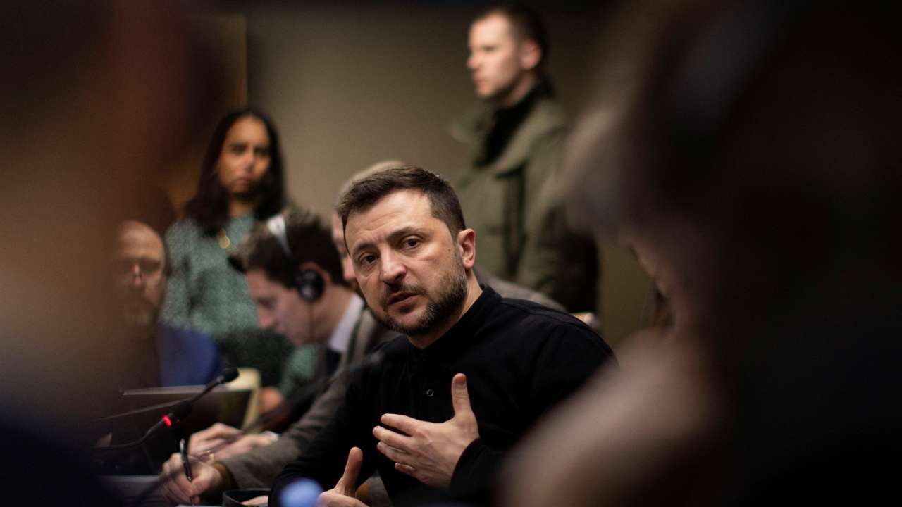 Ukrainian President Volodymyr Zelenskiy gestures during a meeting with members of the media on the outskirts of London