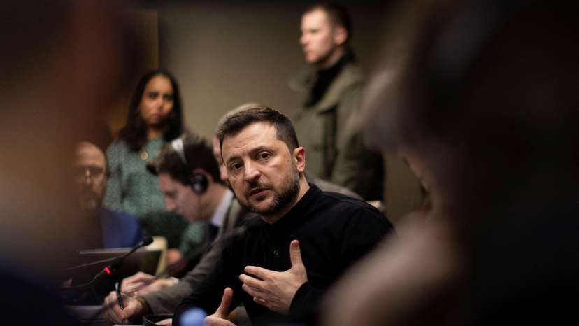 Ukrainian President Volodymyr Zelenskiy gestures during a meeting with members of the media on the outskirts of London