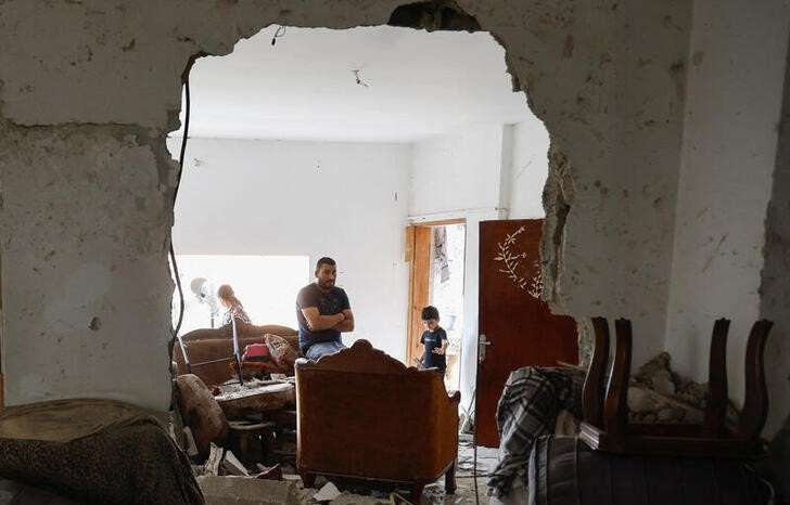 FILE PHOTO: Palestinians inspect the damage, following a several day long Israeli-raid, in Jenin camp