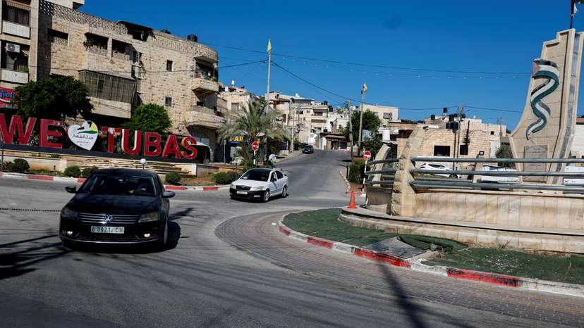 Palestinians drive by signage that reads "We heart Tubas" during a general strike after the assassination of Hamas leader Ismail Haniyeh in Iran, in Tubas