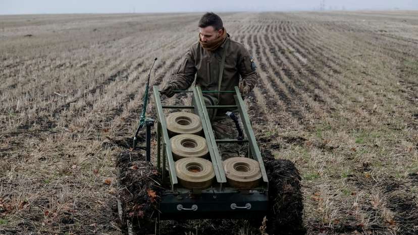FILE PHOTO: A serviceman of the National Guard of Ukraine operates a mine-laying unmanned ground vehicle in Kharkiv region