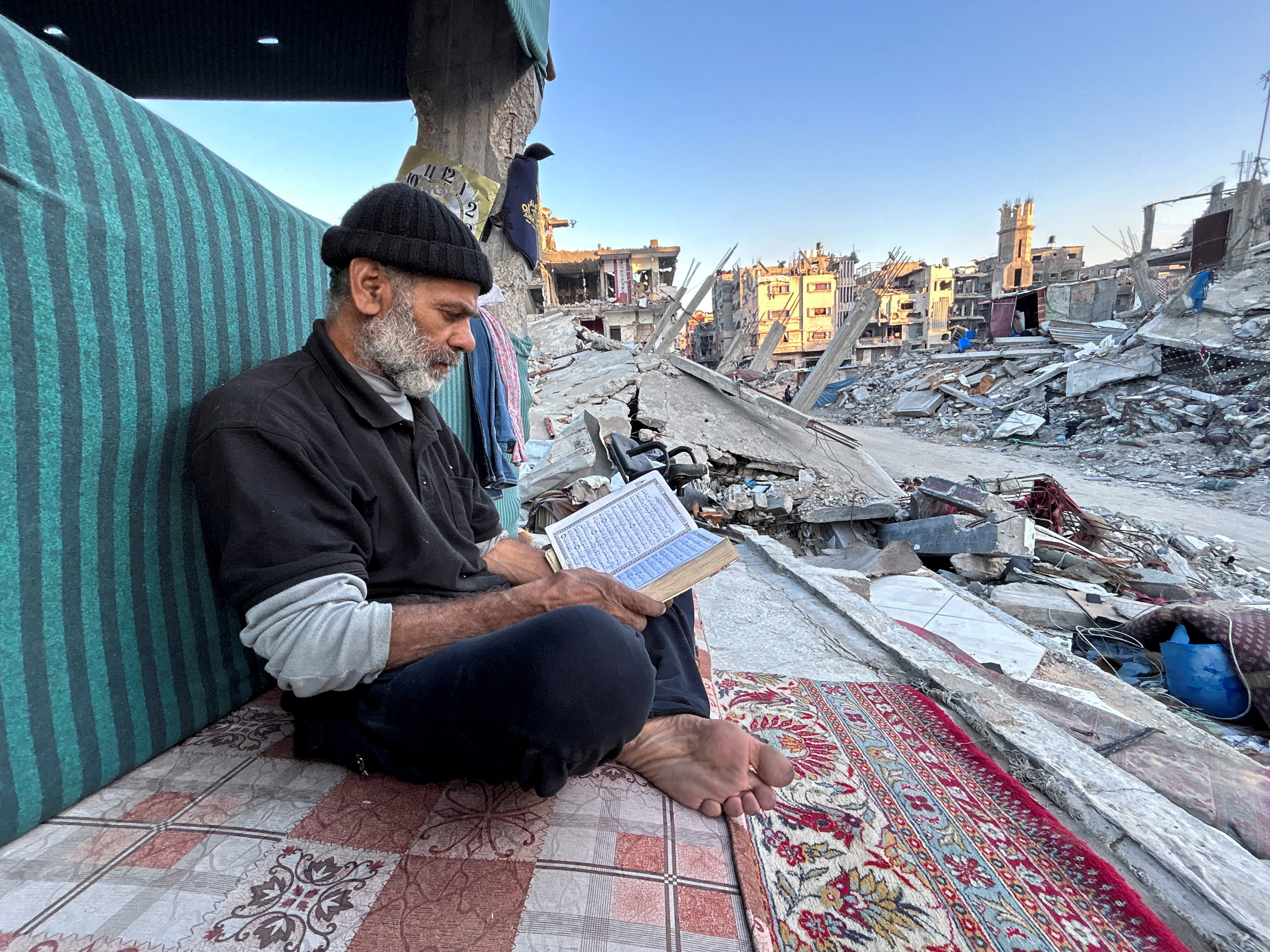 Gaza family breaks Ramadan fast on the rubble of their destroyed house, in Beit Lahia in the northern Gaza Strip