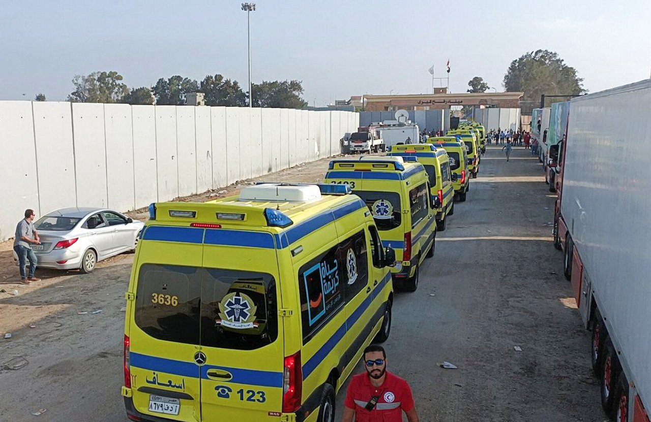 Egyptian ambulances which will carry critically injured people, drive through the Rafah crossing from the Egyptian side