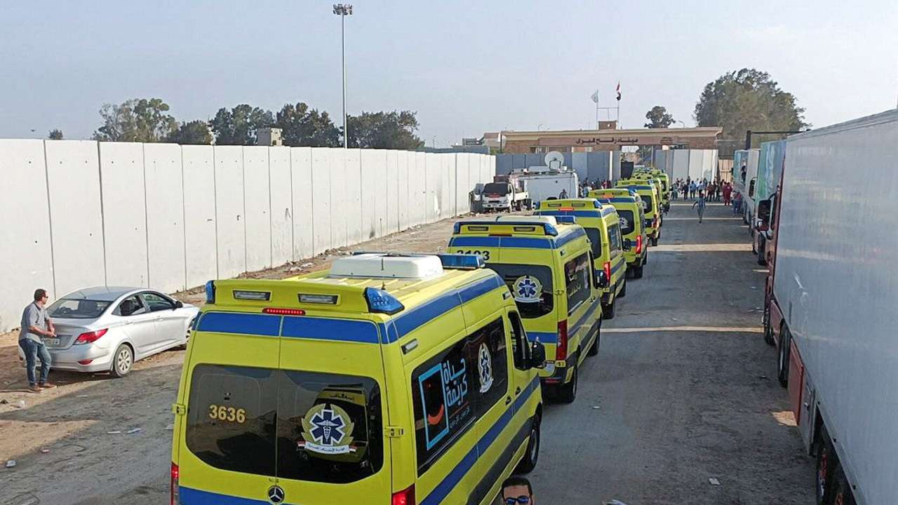 Egyptian ambulances which will carry critically injured people, drive through the Rafah crossing from the Egyptian side