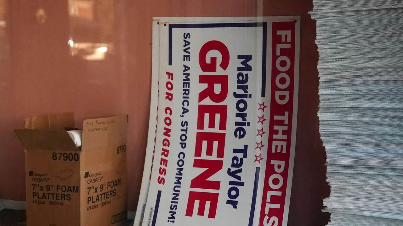 A Marjorie Taylor Greene campaign sign inside a closed republican office in downtown Rome