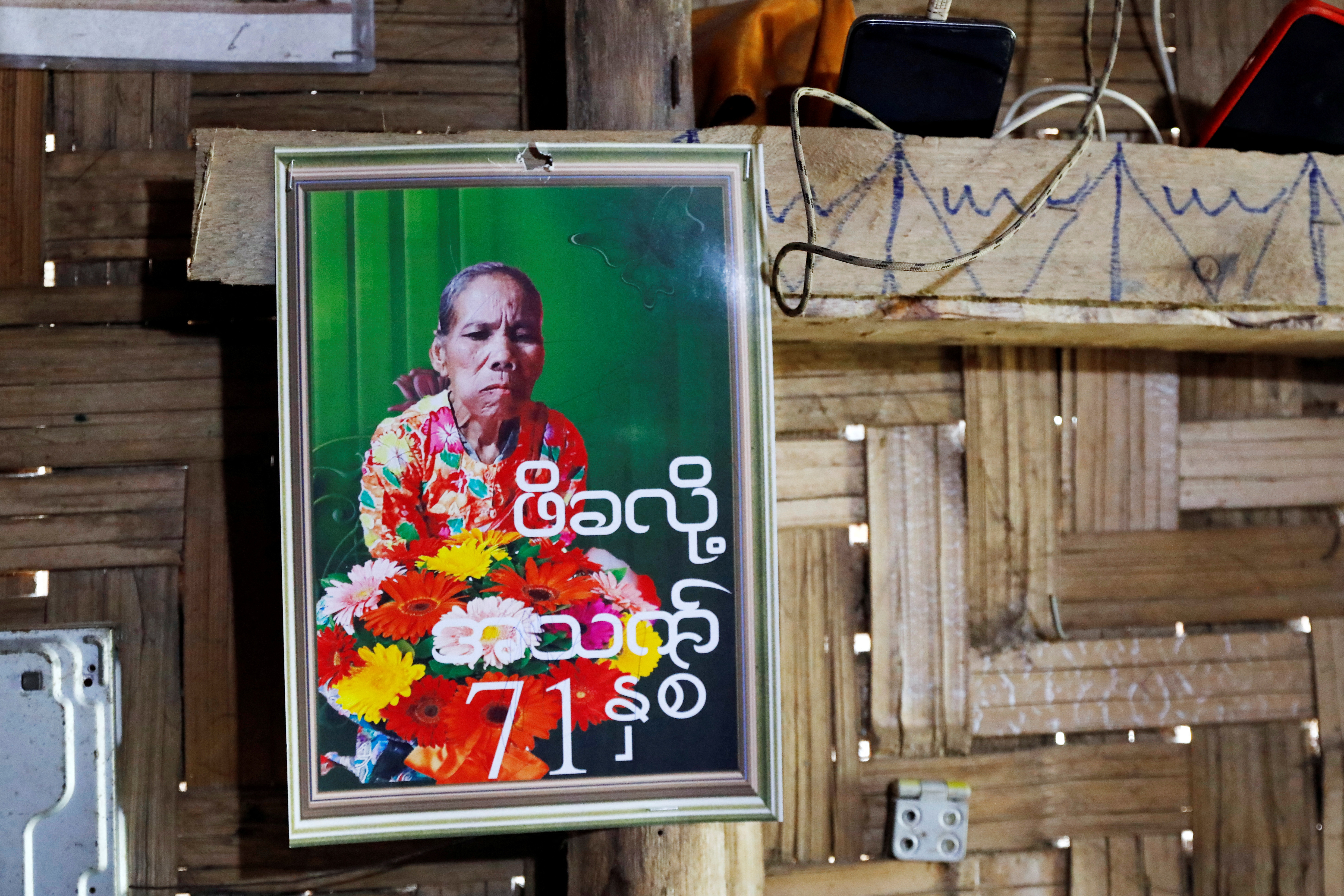 A picture of Pe Kha Lau hangs at Phop Phra district