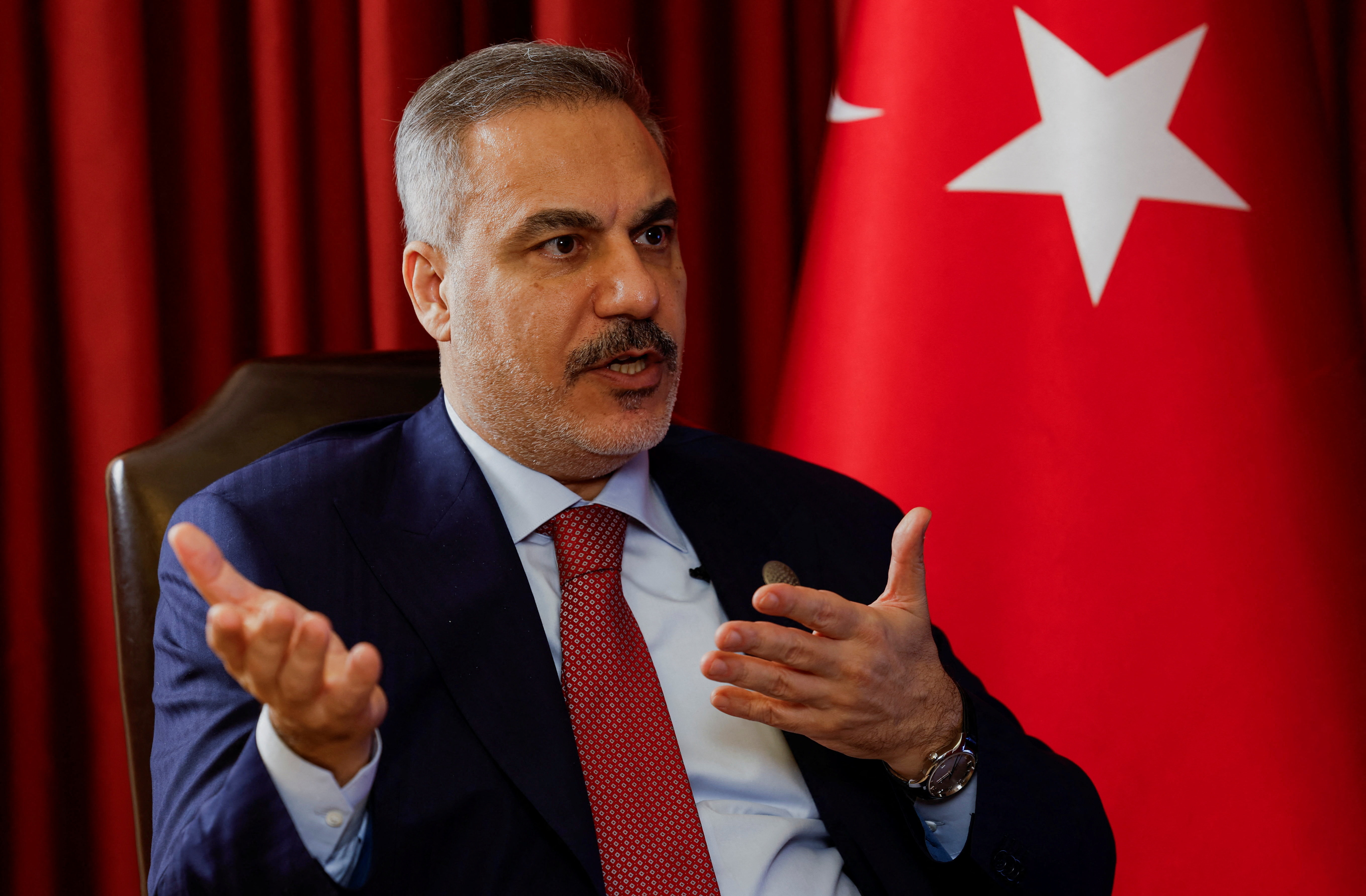 Turkish Foreign Minister Hakan Fidan speaks during an interview with Reuters at the 23rd edition of the annual Doha Forum, in Doha
