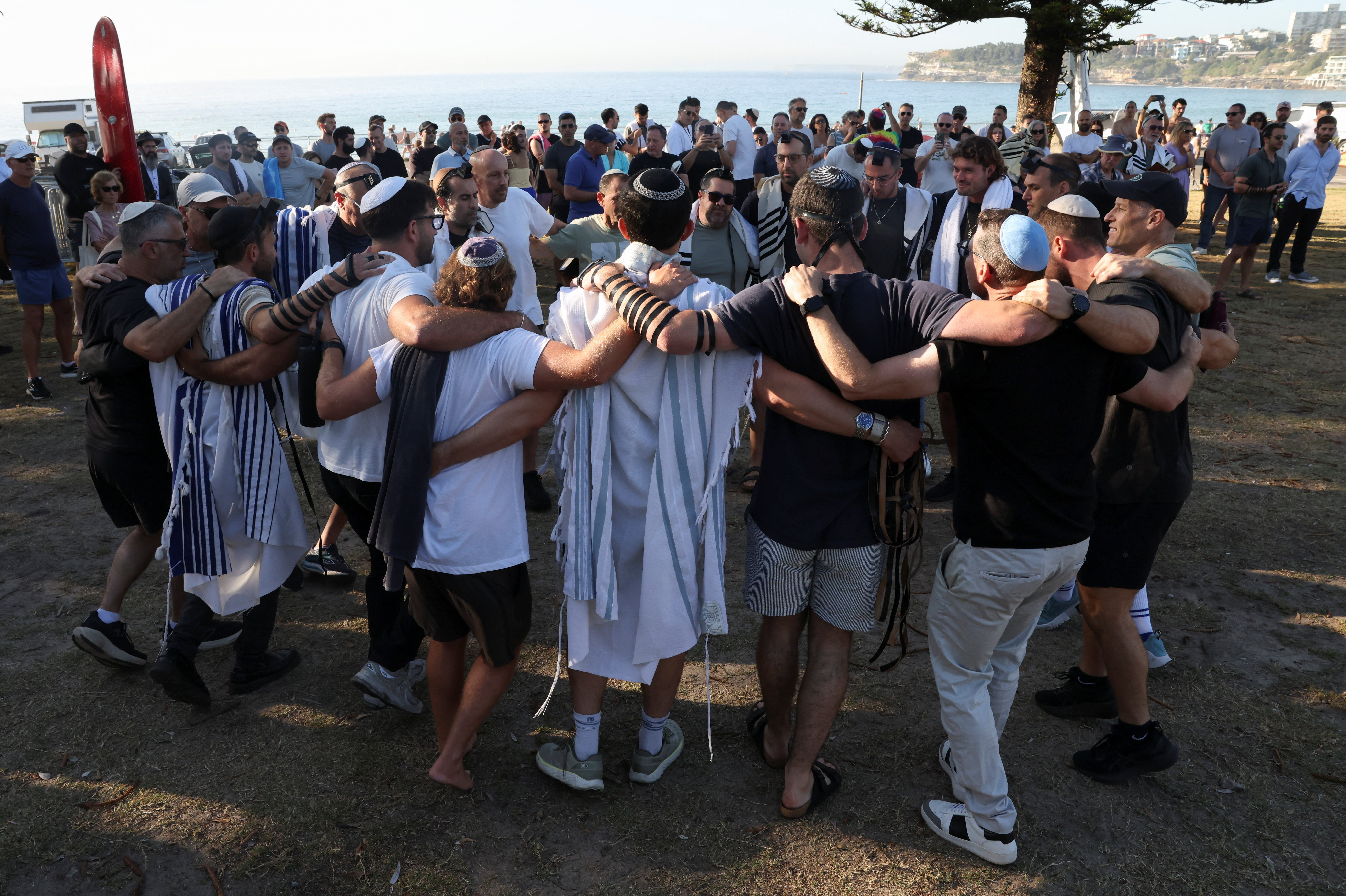 People visit the crime scene after it was reopened following the mass shooting at Bondi Beach