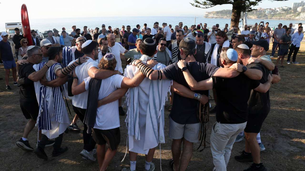 People visit the crime scene after it was reopened following the mass shooting at Bondi Beach