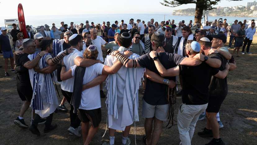 People visit the crime scene after it was reopened following the mass shooting at Bondi Beach