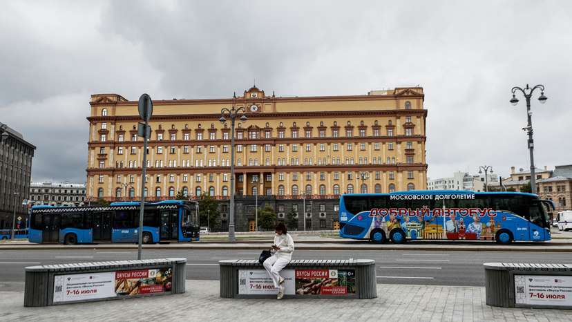 A woman uses her mobile phone in front of the Federal Security Service in Moscow