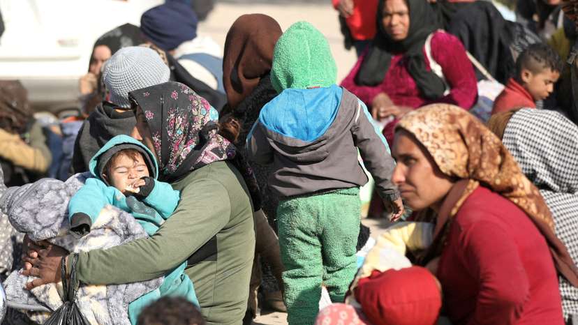 FILE PHOTO: Displaced women who fled Aleppo countryside, sit with their children in Tabqa,