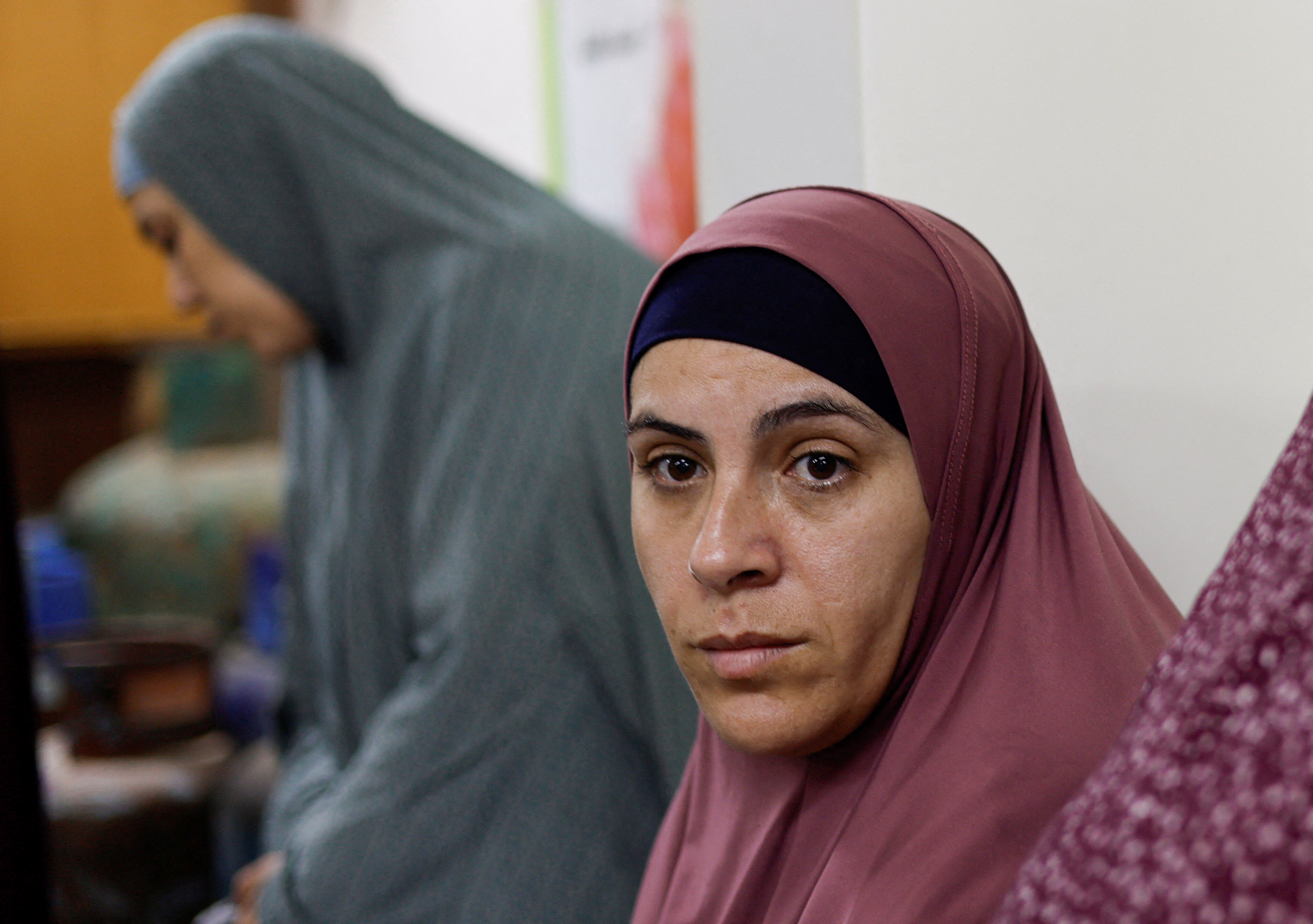 Palestinian woman Tamam al-Aswad who was imprisoned for weeks by Israel, looks on after her release as she takes refuge at a school in Rafah