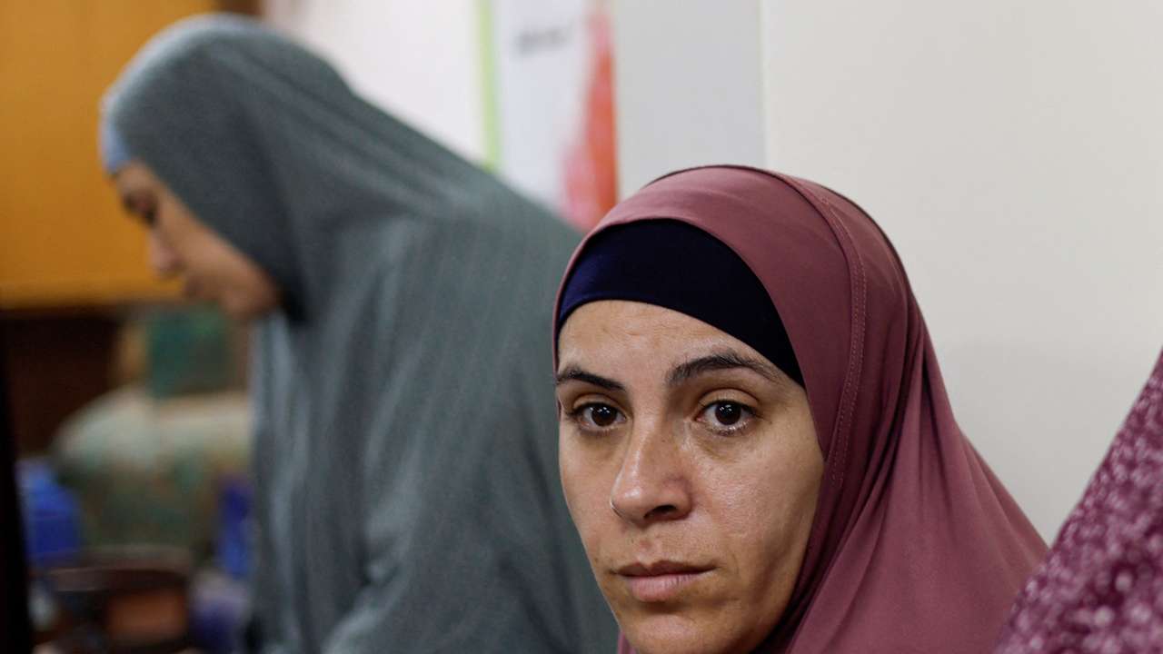 Palestinian woman Tamam al-Aswad who was imprisoned for weeks by Israel, looks on after her release as she takes refuge at a school in Rafah