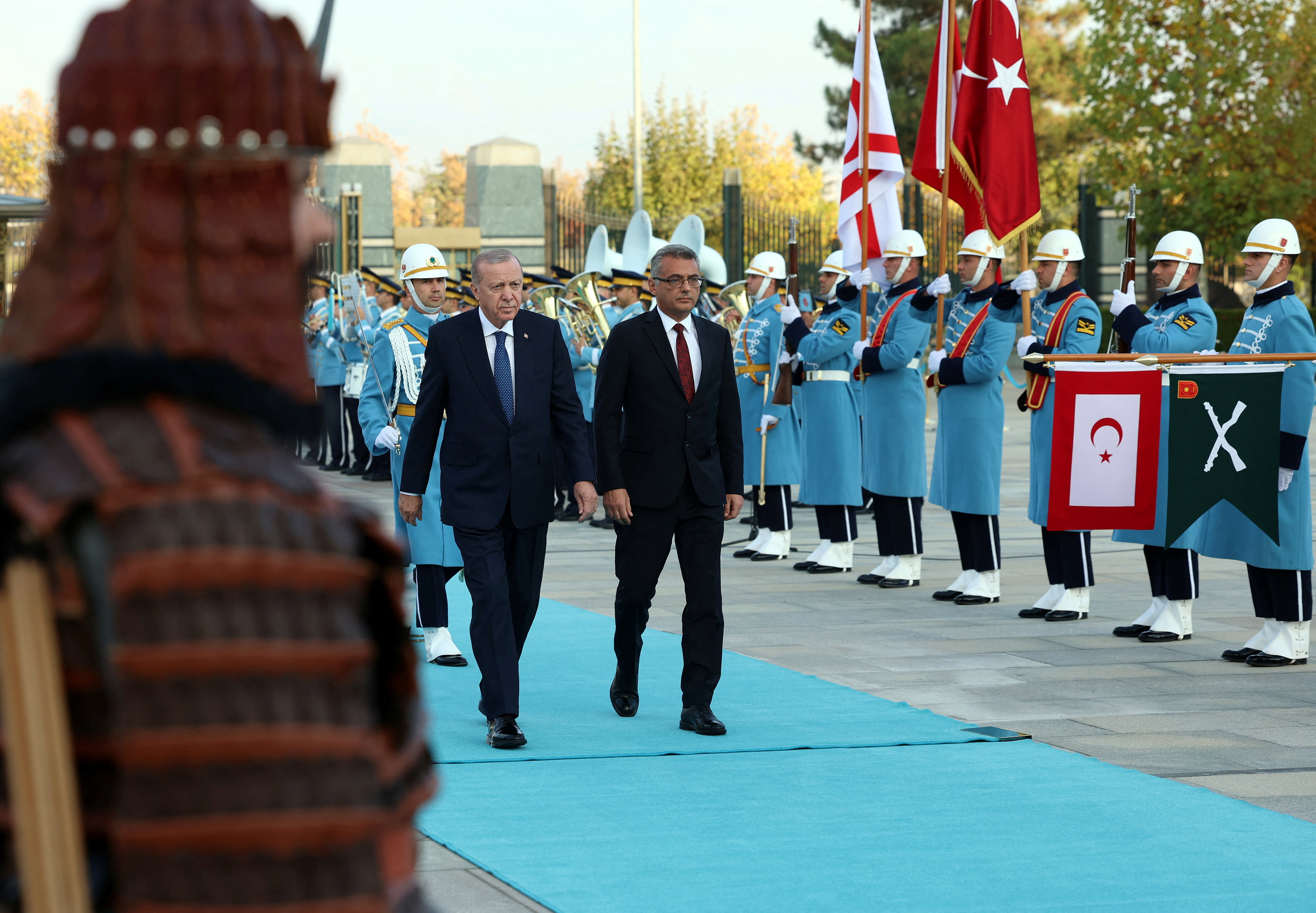Turkey's President Tayyip Erdogan and Turkish Cypriot leader Tufan Erhurman attend a welcoming ceremony at the Presidential Palace in Ankara