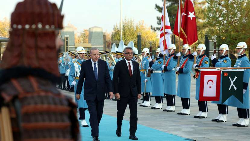 Turkey's President Tayyip Erdogan and Turkish Cypriot leader Tufan Erhurman attend a welcoming ceremony at the Presidential Palace in Ankara