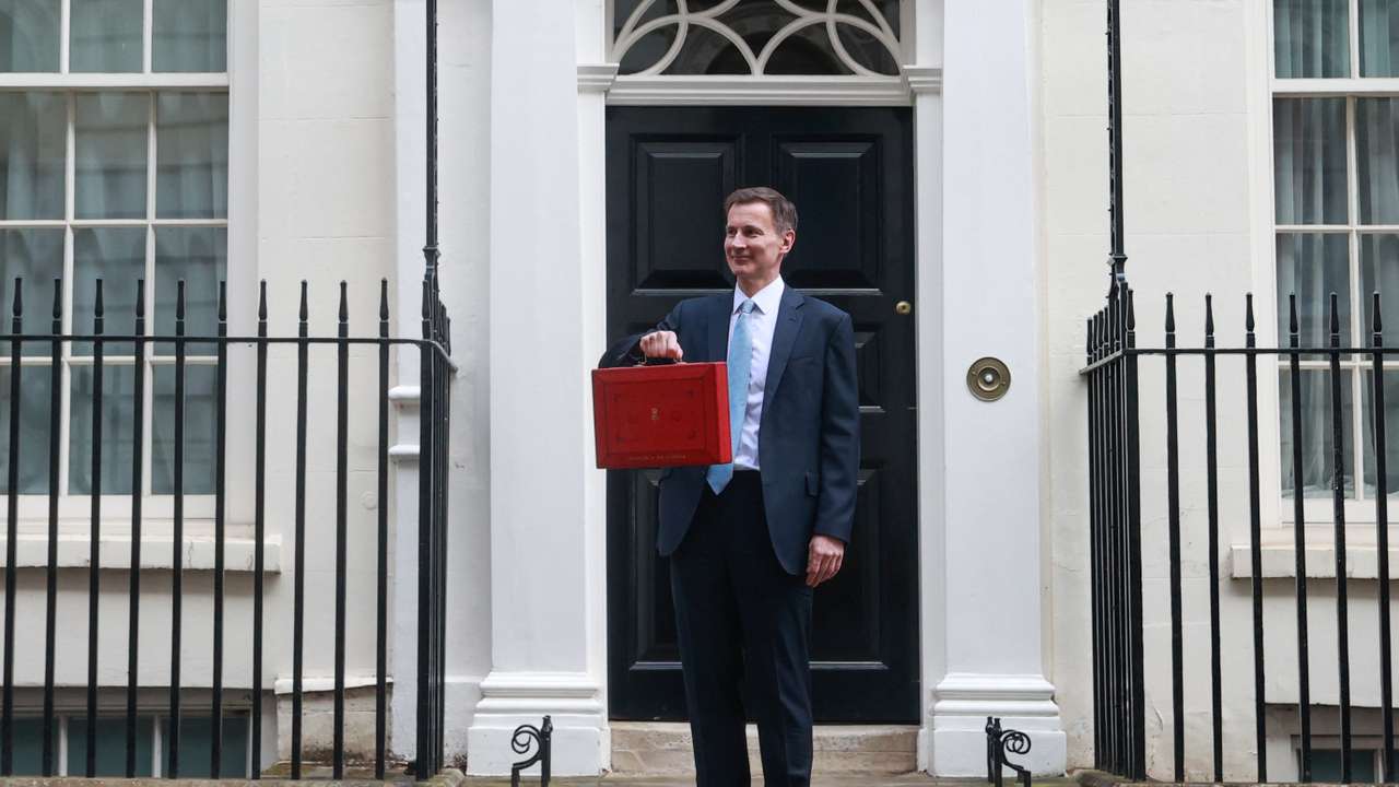 British Chancellor of the Exchequer Jeremy Hunt holds the budget box on Downing Street in London