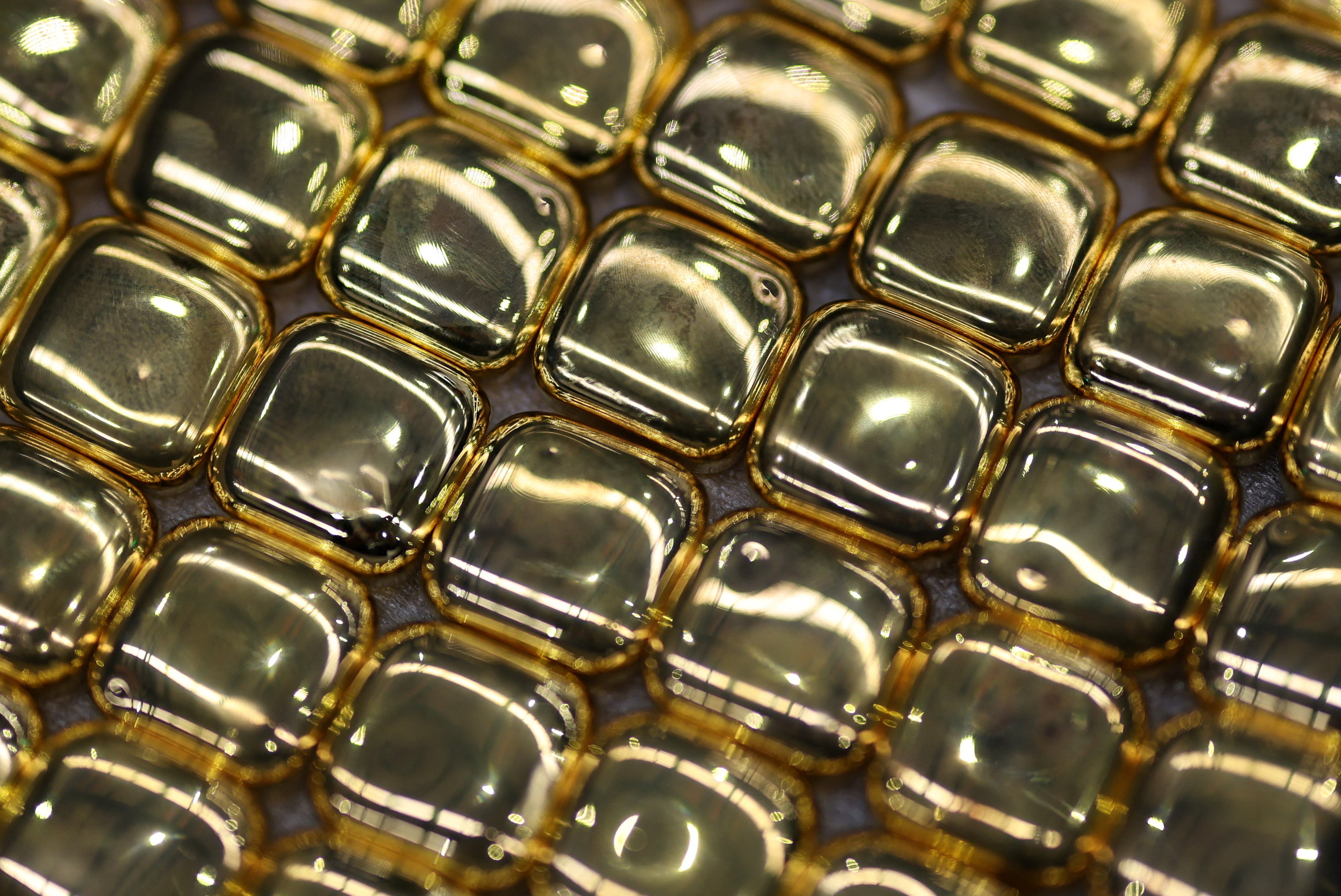 One-ounce gold bullion bars lie ready for stamping during production at ABC Refinery, in Sydney