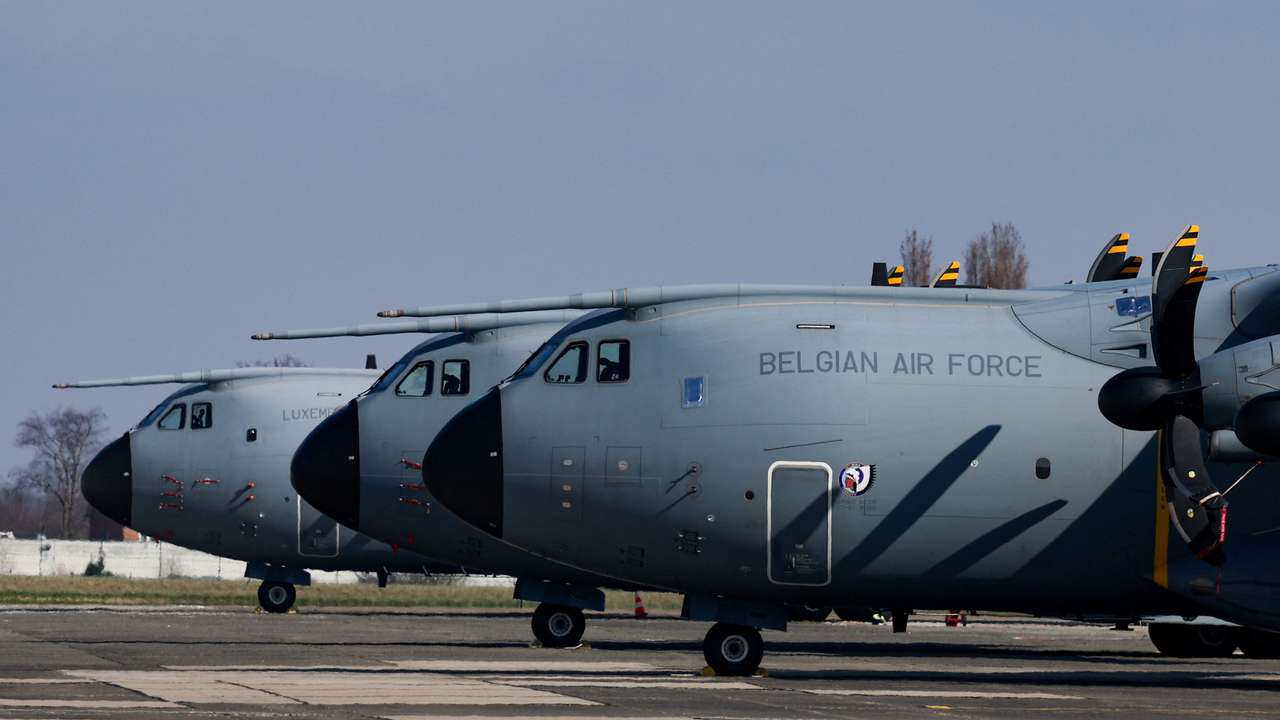 A Belgian Air Force Airbus A400M Atlas is parked next to aircrafts, in Melsbroek