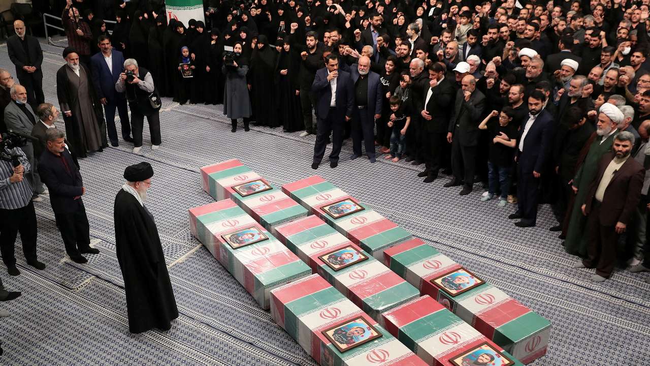 Iran's Supreme Leader, Ayatollah Ali Khamenei looks at the coffins of members of the Islamic Revolutionary Guard Corps, in Tehran