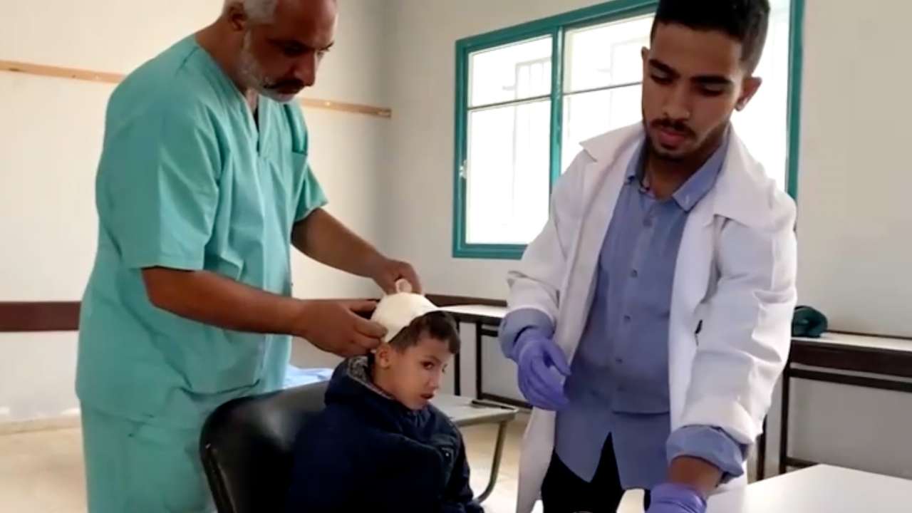 Doctors attend to a patient at a field clinic inside a central Gaza school in Deir Al-Balah, in this screengrab taken from a video.