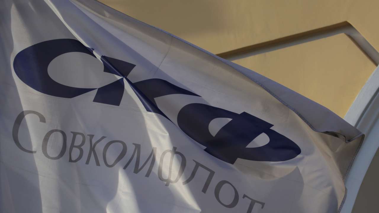 A flag depicting the logo of the Russian state-owned shipping conglomerate Sovcomflot flies outside the company's hearquarters in St. Petersburg
