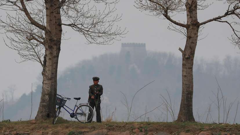 A North Korean soldier keeps watch at the Yalu River in Sinuiju, North Korea, which borders Dandong