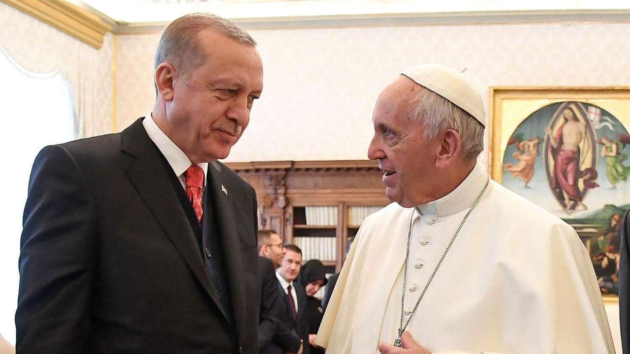 Pope Francis talks with Turkish President Tayyip Erdogan during a private audience at the Vatican