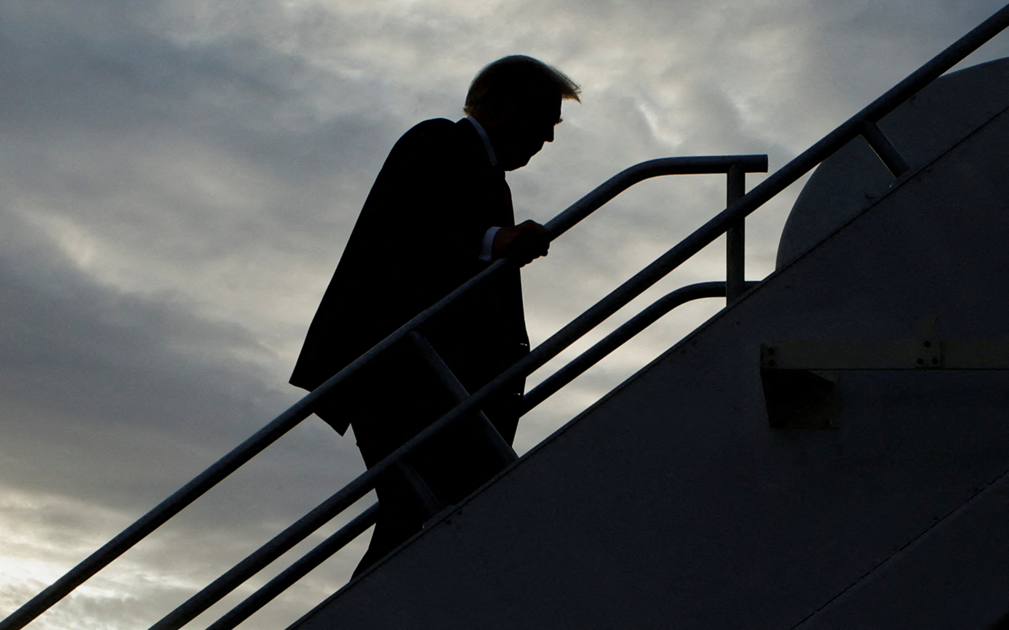 FILE PHOTO: Former U.S. President and Republican presidential candidate Donald Trump boards his plane to depart from Eastern Iowa Airport