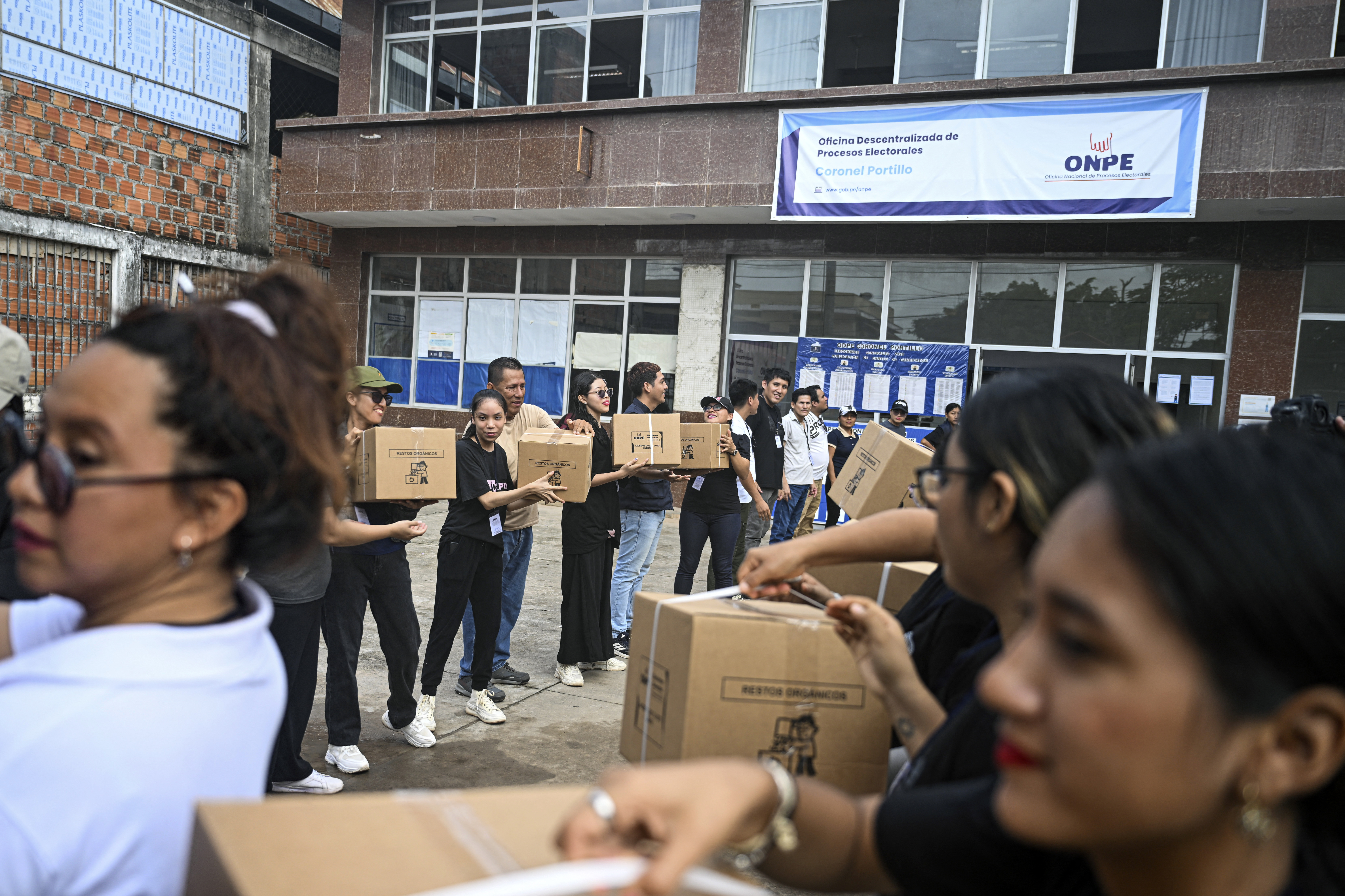 Volunteers of the ONPE (National Office of Electoral Processes) transport electoral material to its Coronel Portillo offices in the department of Ucayali in the central-eastern jungle of Peru, on April 11, 2026. Peru, which has had eight presidents in ten years, will hold general election on April 12, 2026, in which voters will have to choose among 35 candidates. (Photo by Hugo Alejos / AFP)