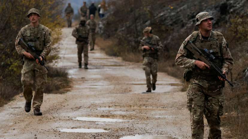 British troops part of the NATO reinforcements patrol at the Kosovo-Serbia border, in Jarinje