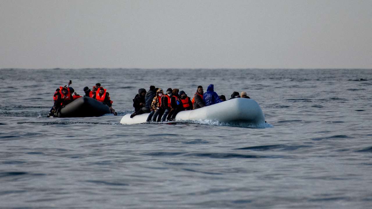 Migrants cross the English Channel in small boats