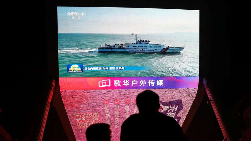 Screen shows news footage of military drills conducted in areas around the island of Taiwan by the Eastern Theatre Command of the Chinese PLA, in Beijing