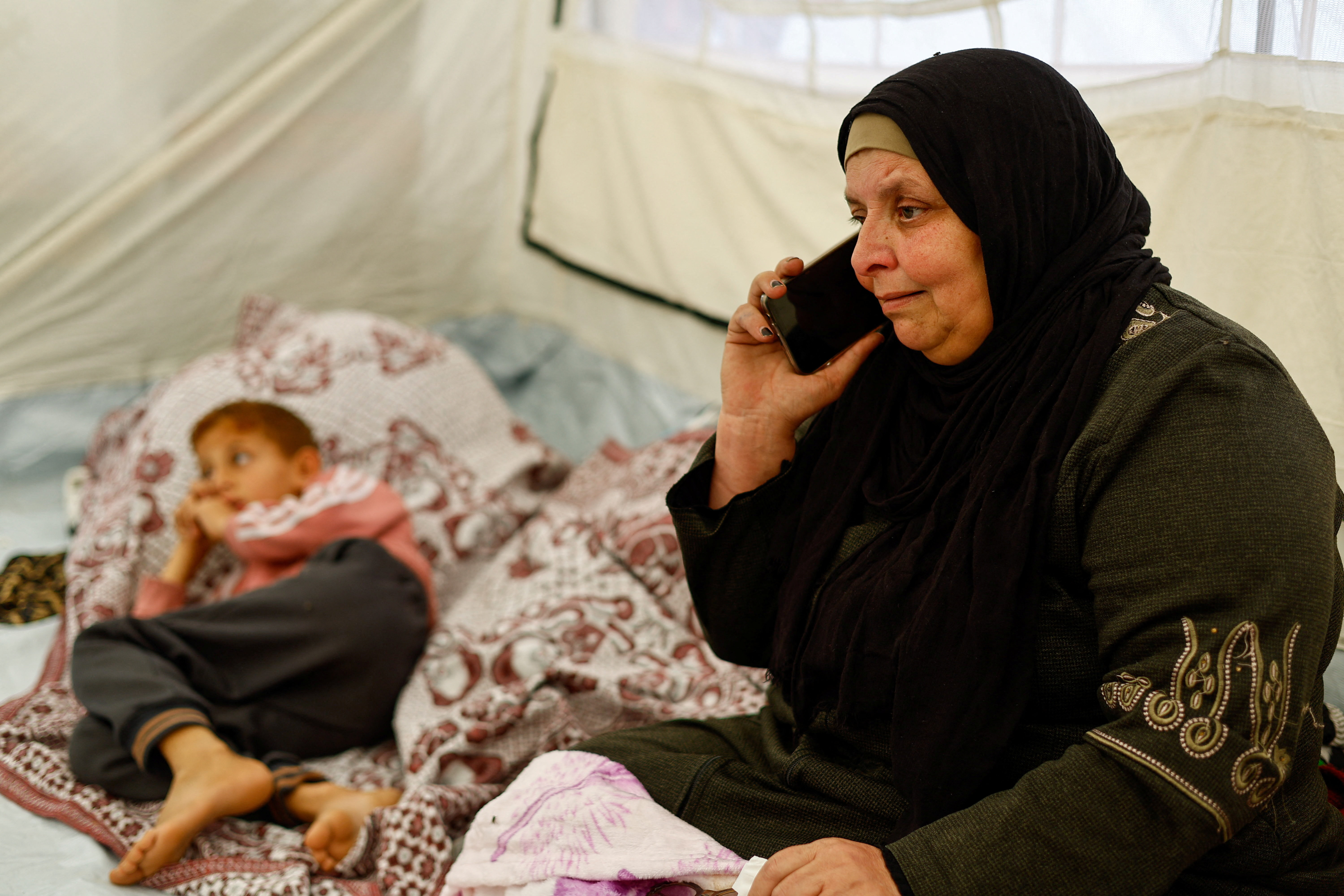 Huda Abu Abed, 56, at a tent shelter after returning to Gaza through the Rafah crossing, in Khan Younis