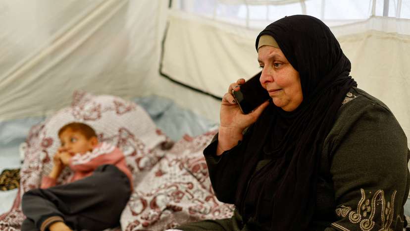 Huda Abu Abed, 56, at a tent shelter after returning to Gaza through the Rafah crossing, in Khan Younis