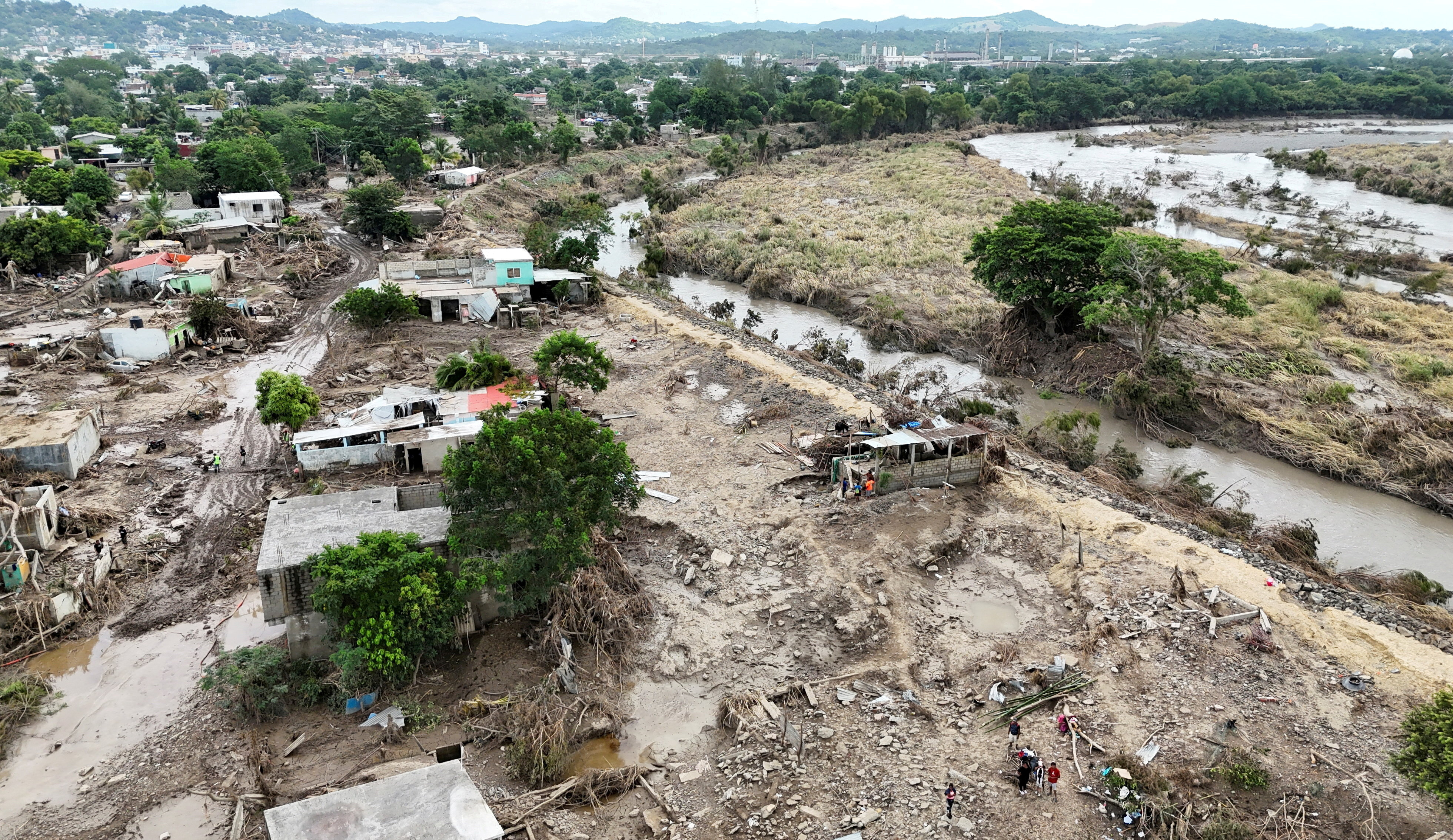 FILE PHOTO: Drone view shows fallen trees, debris and damaged houses amid muddy floodwater after a river overflowed following torrential rains, in Mexico
