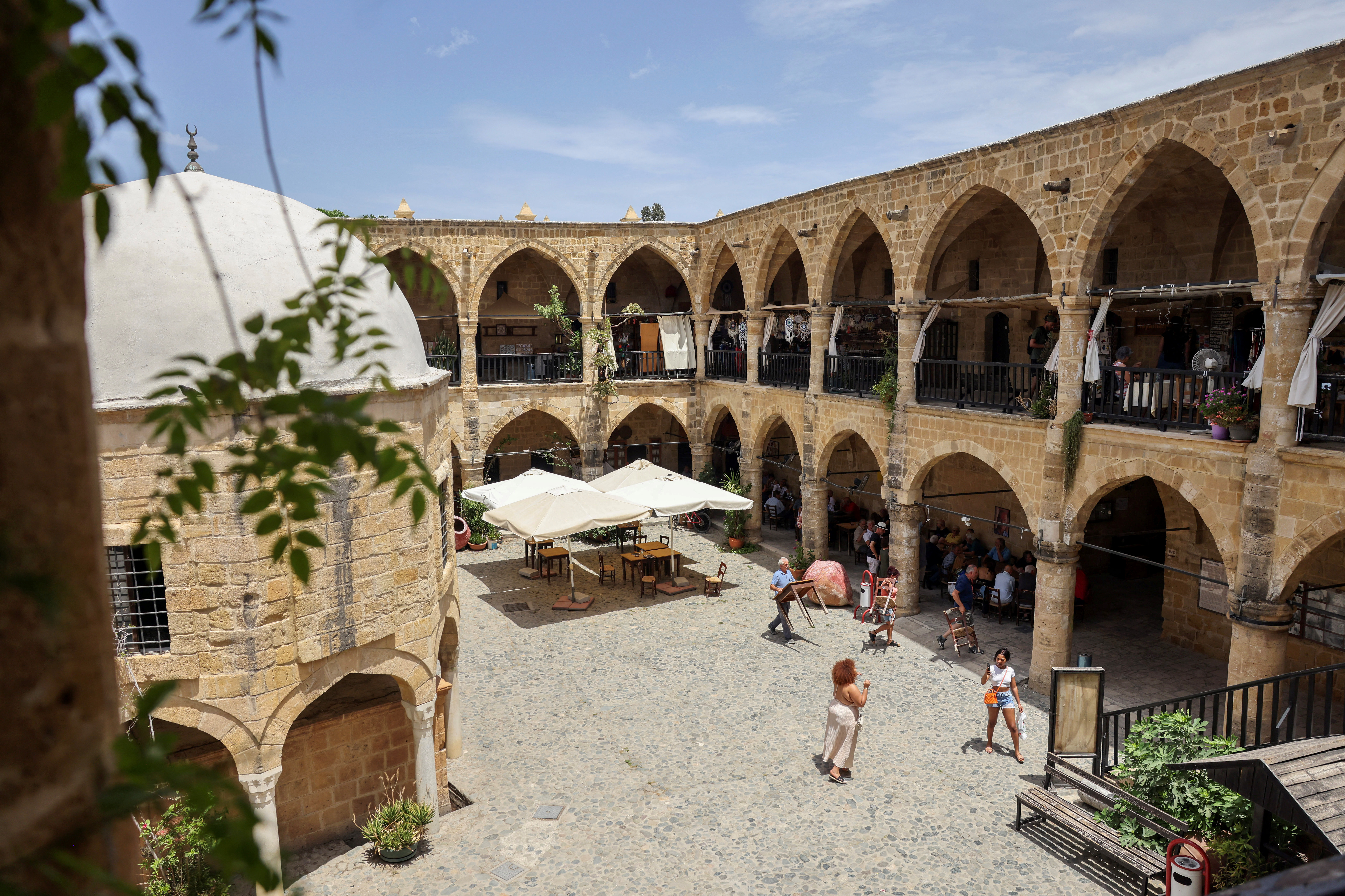 People walk inside the 16th century Buyuk Han in Cyprus’s ethnically split capital Nicosia
