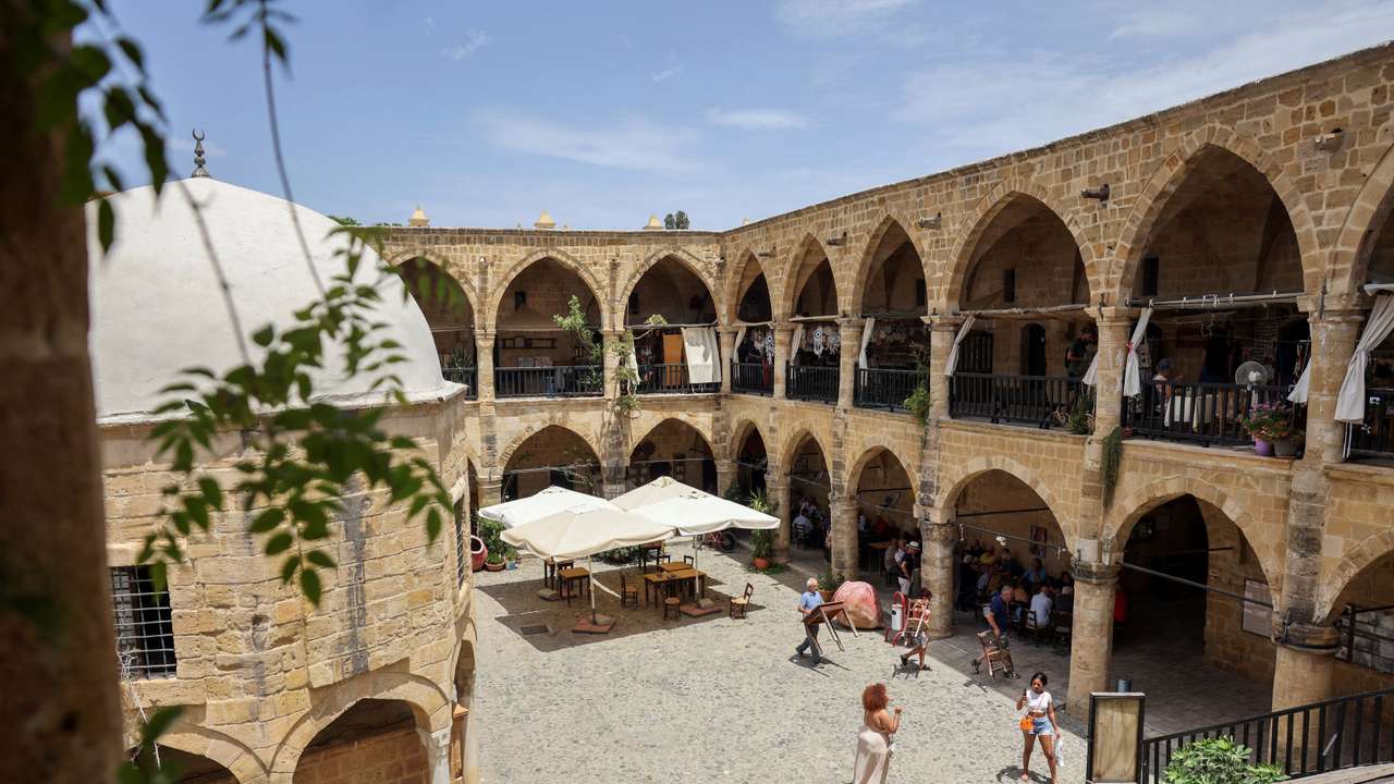 People walk inside the 16th century Buyuk Han in Cyprus’s ethnically split capital Nicosia