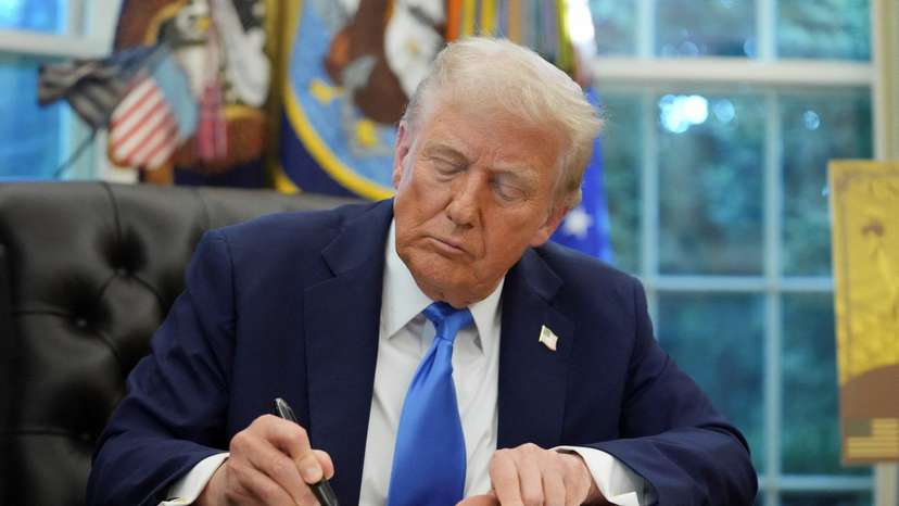 FILE PHOTO: U.S. President Donald Trump signs executive orders in the Oval Office at the White House in Washington