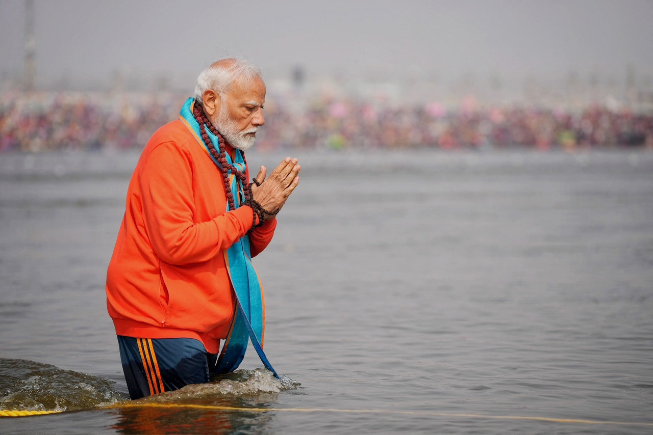 India's Prime Minister Narendra Modi prays as he takes a holy dip during the ongoing "Maha Kumbh Mela", or the Great Pitcher Festival, in Prayagraj