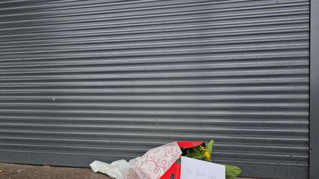 Flowers left outside tobacco shop owned by "Bondi hero" Ahmed al Ahmed, in Sydney